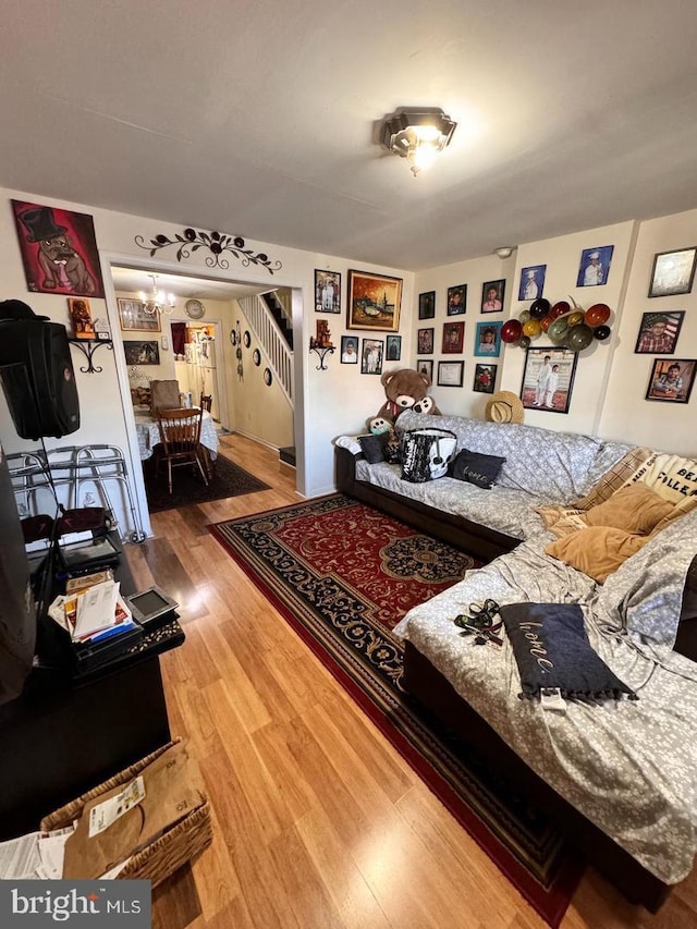 living room with hardwood / wood-style floors and an inviting chandelier