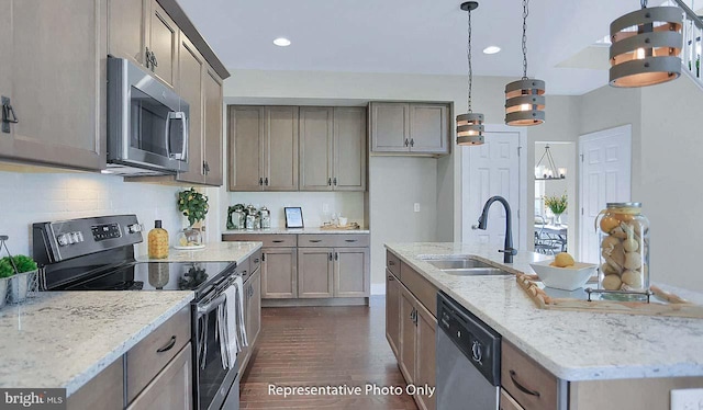 120 Forge Dr, Lebanon, PA 17042 - kitchen with light stone countertops, sink, hanging light fixtures, stainless steel appliances, and a kitchen island with sink