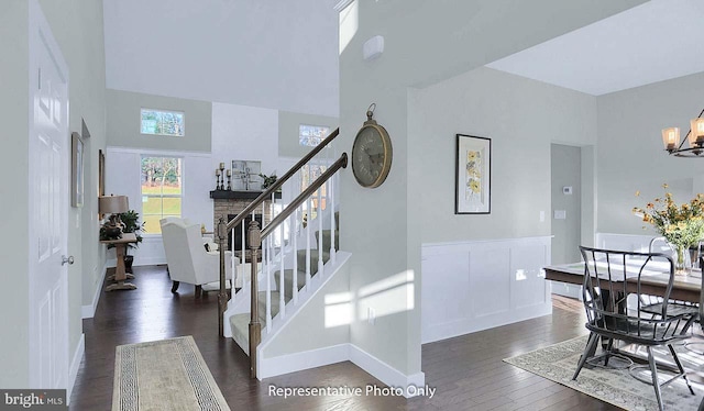 120 Forge Dr, Lebanon, PA 17042 - stairs featuring wood-type flooring, a towering ceiling, and an inviting chandelier