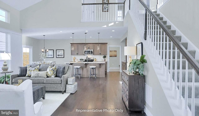 120 Forge Dr, Lebanon, PA 17042 - living room featuring a high ceiling, an inviting chandelier, a wealth of natural light, and dark wood-type flooring