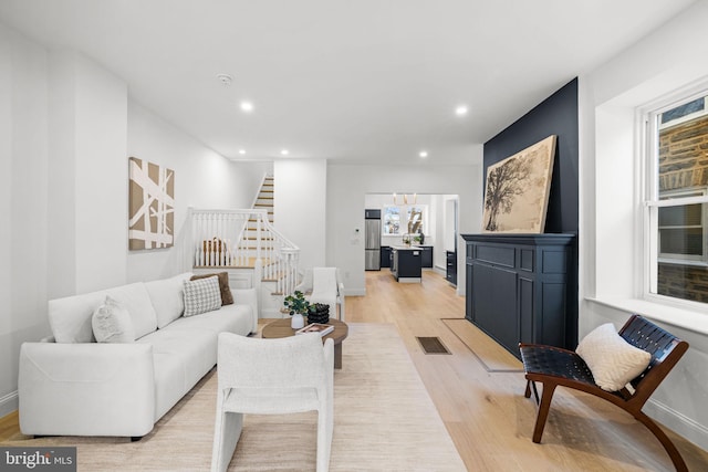 living room featuring plenty of natural light and light hardwood / wood-style floors