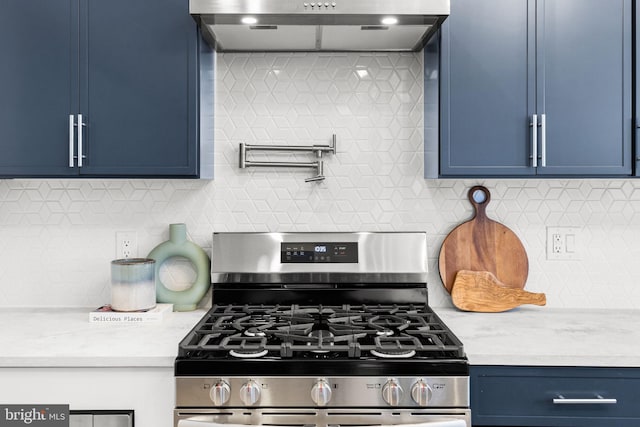 kitchen featuring tasteful backsplash, stainless steel range with gas cooktop, and blue cabinets