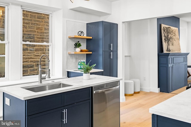 kitchen with dishwasher, light hardwood / wood-style floors, blue cabinetry, and sink