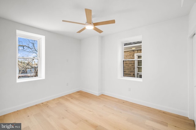 spare room with light wood-type flooring and ceiling fan