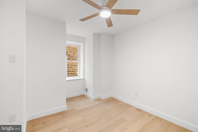 spare room featuring light hardwood / wood-style flooring and ceiling fan