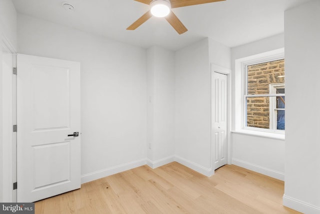 empty room featuring ceiling fan and light hardwood / wood-style flooring