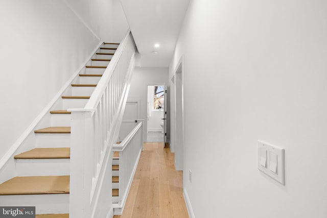 stairway featuring wood-type flooring