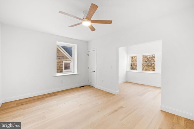 spare room featuring light hardwood / wood-style floors and ceiling fan