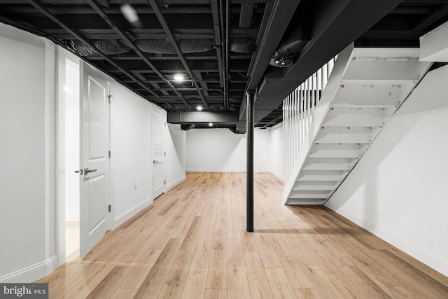 basement with light hardwood / wood-style floors