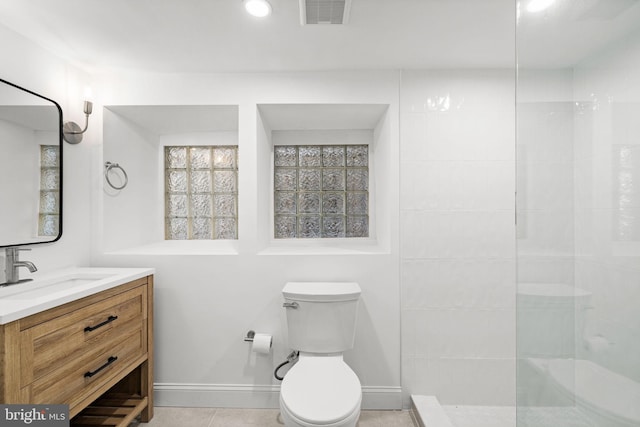 bathroom featuring walk in shower, tile patterned floors, vanity, and toilet