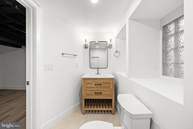 bathroom with tile patterned flooring, vanity, and toilet