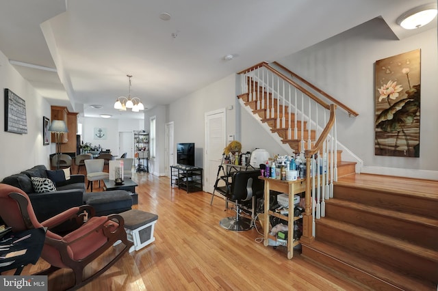 living room featuring light hardwood / wood-style floors and a chandelier