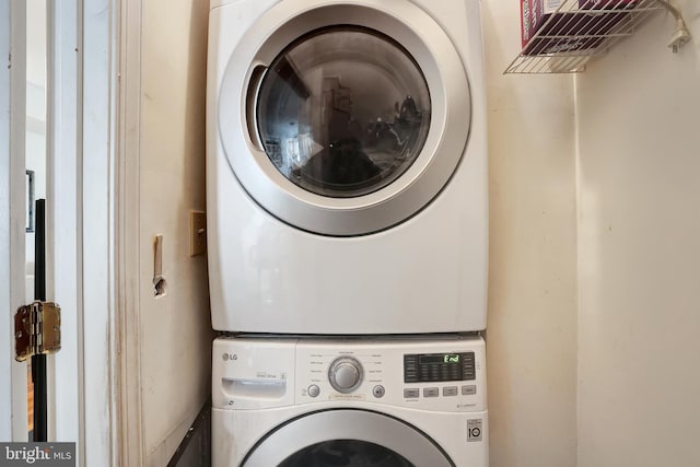 laundry area featuring stacked washer and dryer