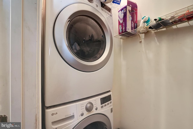 washroom with stacked washer / drying machine