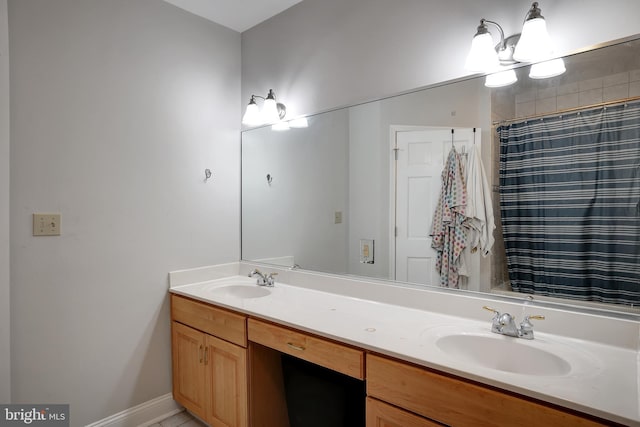 bathroom featuring curtained shower and vanity