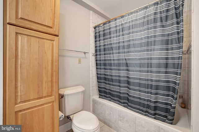 bathroom with shower / bath combo and toilet