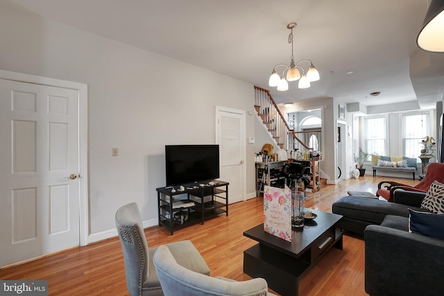 living room featuring hardwood / wood-style floors and a notable chandelier