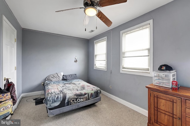 bedroom with ceiling fan and light carpet