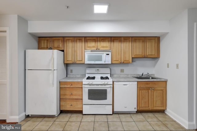 kitchen with white appliances, sink, and light tile patterned floors