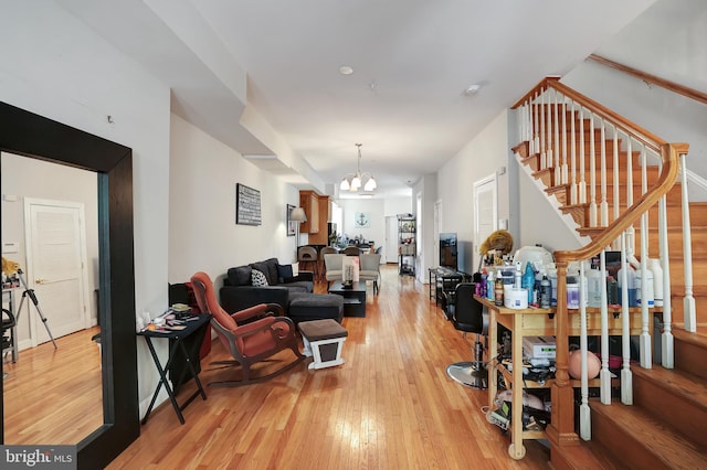 living room featuring light hardwood / wood-style flooring and a chandelier