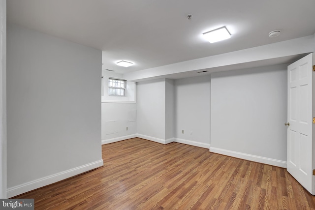 basement with hardwood / wood-style floors