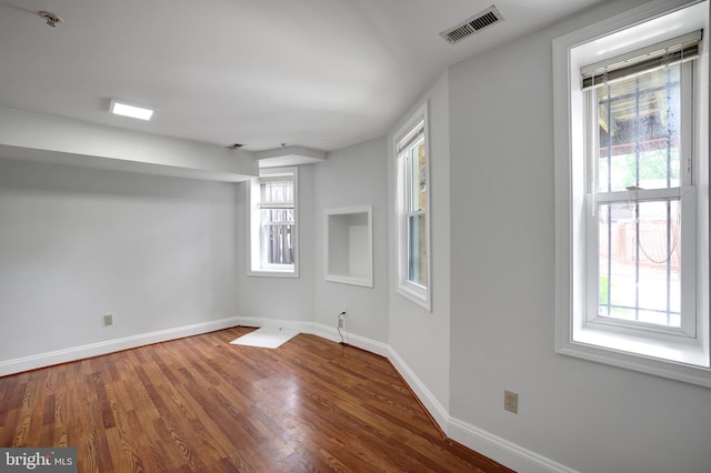 unfurnished room with hardwood / wood-style flooring