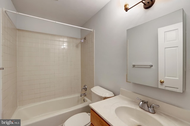 full bathroom with vanity, toilet, and tiled shower / bath