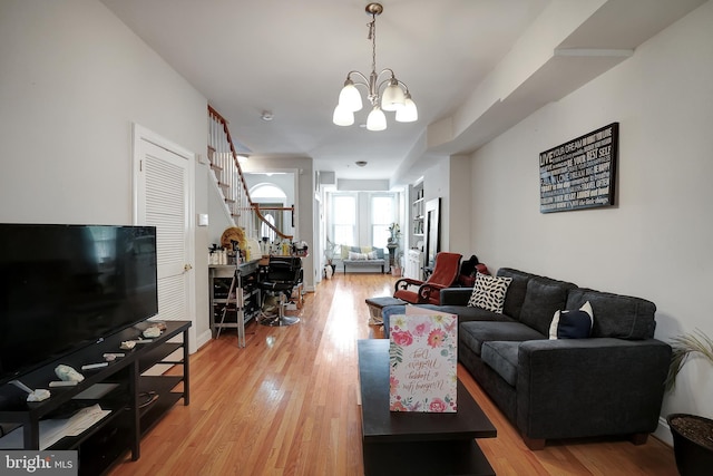 living room with hardwood / wood-style flooring and an inviting chandelier