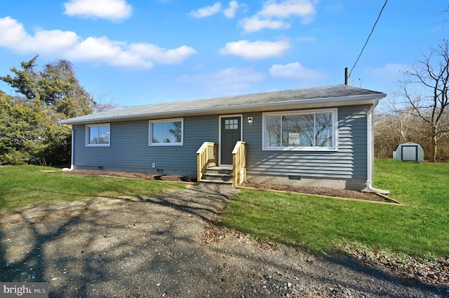 view of front of property featuring a front lawn and a storage shed