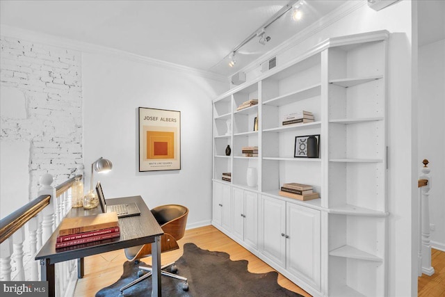 office area featuring crown molding, light wood-type flooring, and rail lighting