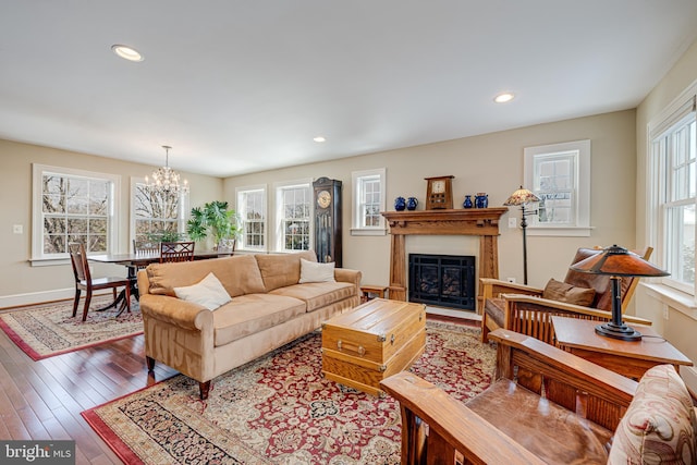 living room with hardwood / wood-style flooring and a chandelier