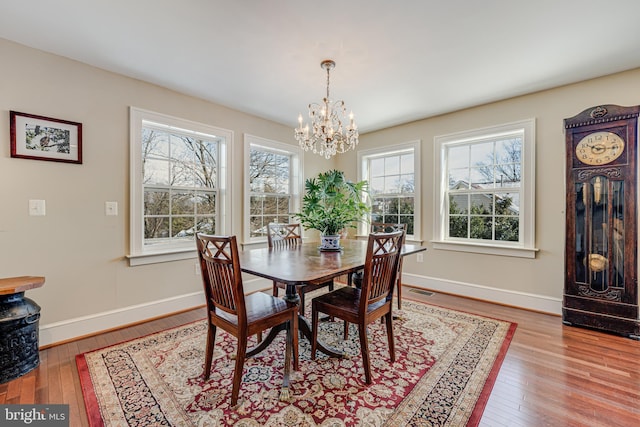 dining room featuring light hardwood / wood-style flooring and a chandelier