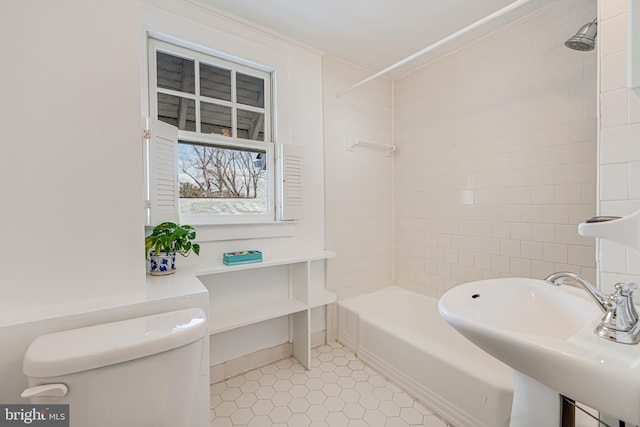 full bathroom featuring tile patterned flooring, tiled shower / bath, sink, and toilet