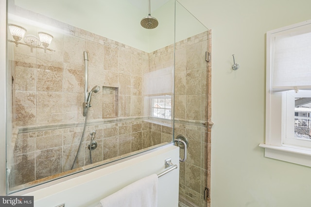 bathroom featuring a shower with door