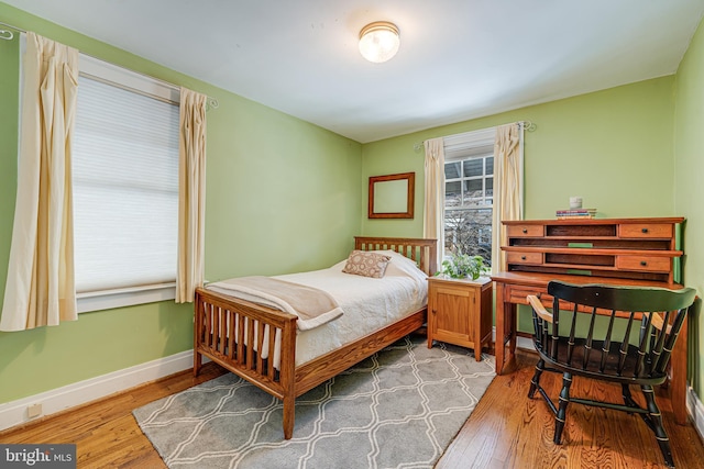 bedroom with hardwood / wood-style floors