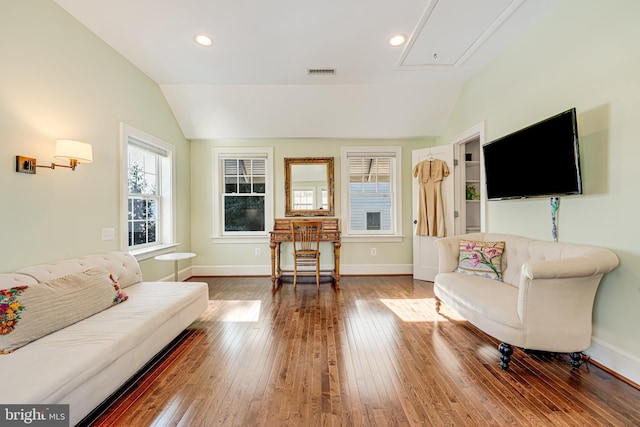 living room featuring lofted ceiling and hardwood / wood-style floors