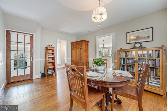 dining room featuring a notable chandelier and light hardwood / wood-style flooring