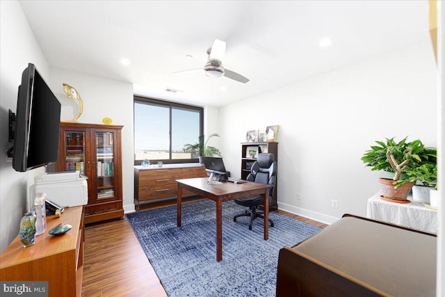 office area featuring ceiling fan and dark wood-type flooring