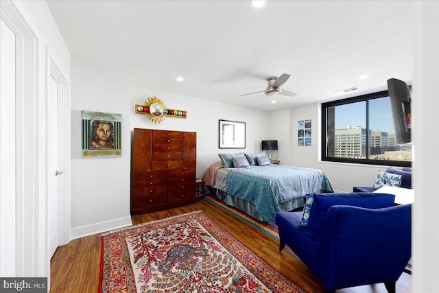 bedroom featuring ceiling fan and dark wood-type flooring