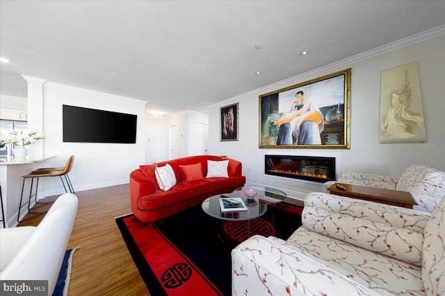 living room with hardwood / wood-style flooring and crown molding