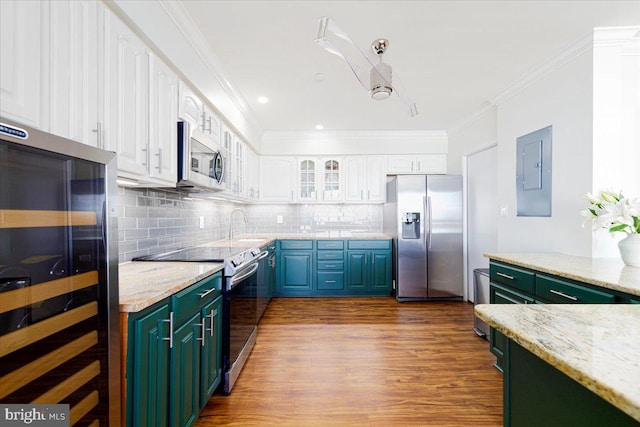 kitchen with backsplash, electric panel, white cabinets, light stone counters, and stainless steel appliances