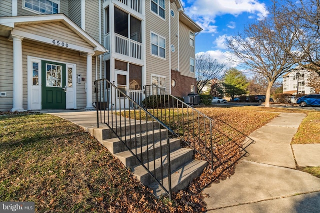 doorway to property featuring central AC unit