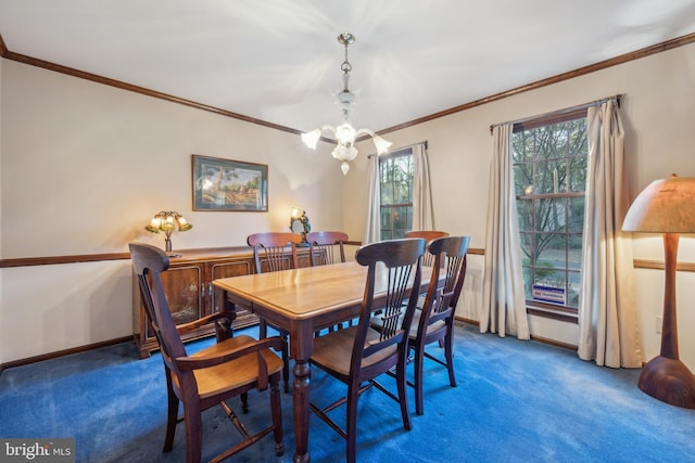 dining space with carpet flooring, a chandelier, and ornamental molding