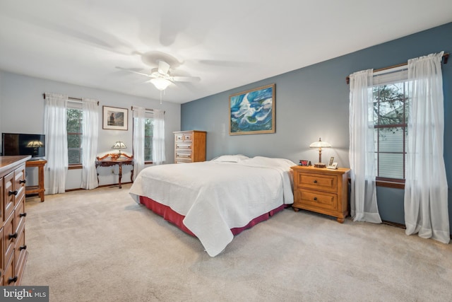 bedroom featuring light carpet and ceiling fan