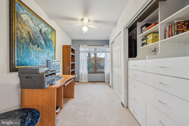 office with light colored carpet and ceiling fan