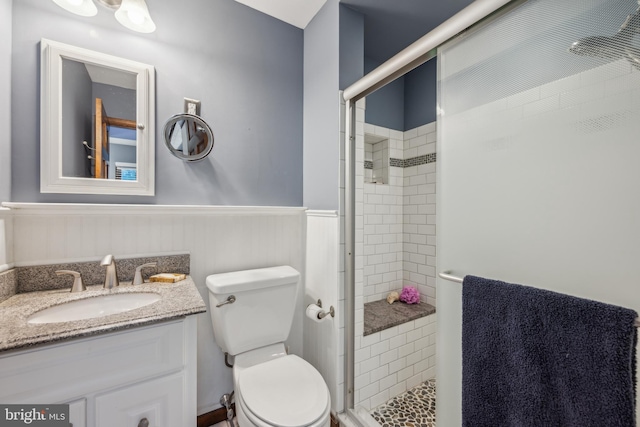 bathroom with vanity, toilet, and walk in shower