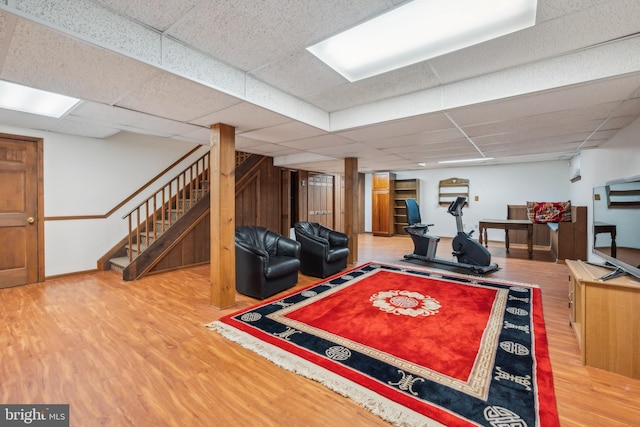 interior space featuring a drop ceiling and hardwood / wood-style flooring