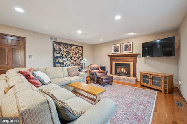 living room with a fireplace and light hardwood / wood-style floors