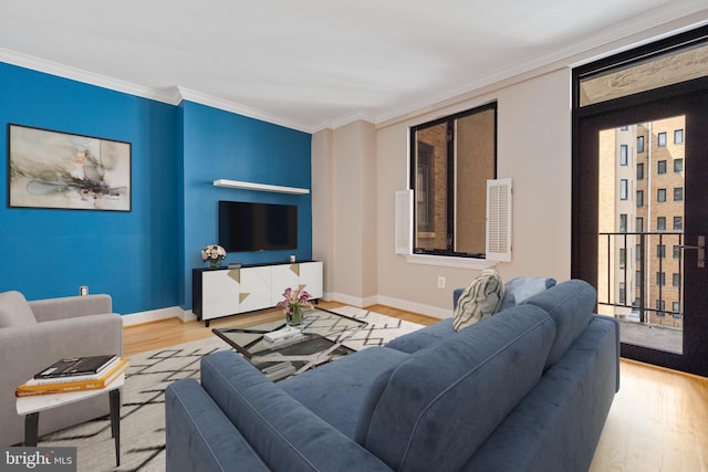 living room with light hardwood / wood-style floors and crown molding