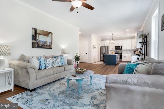 living room with wood-type flooring, ceiling fan, and crown molding